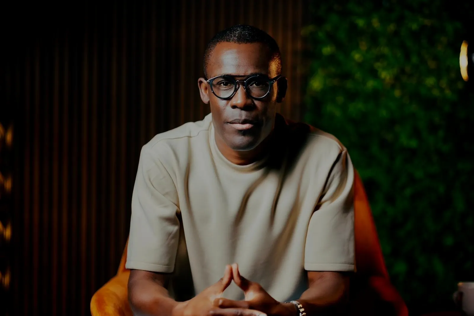 Peter Komolafe looking at the camera in a studio
