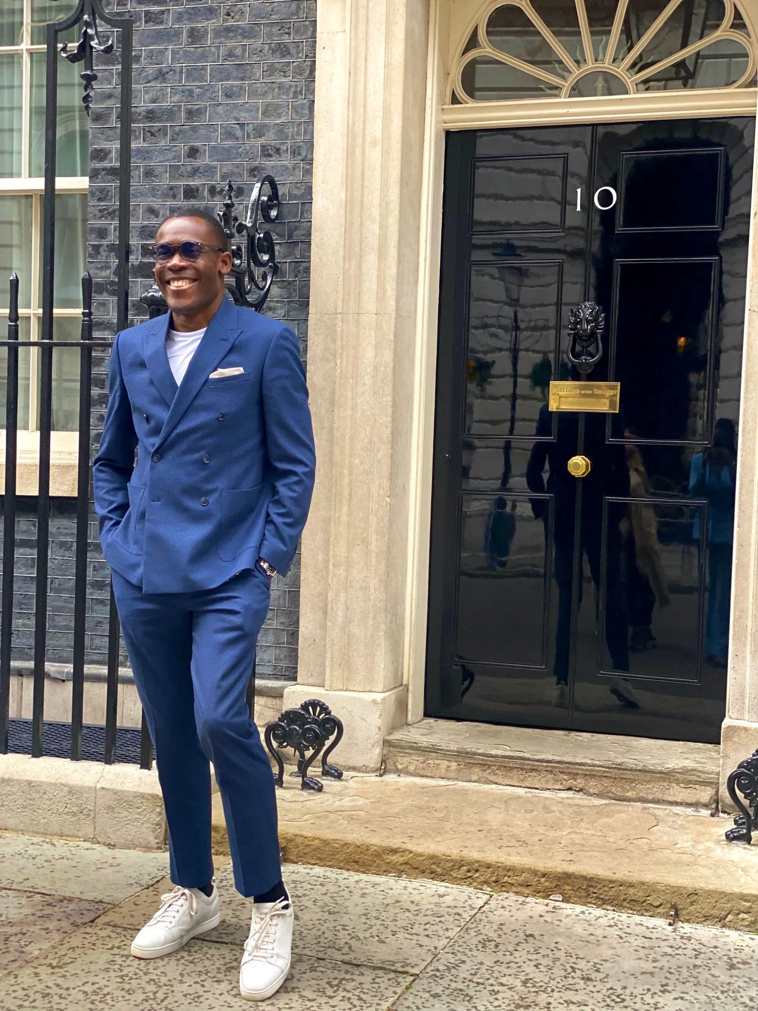 Peter Komolafe smiling outside 10 Downing Street