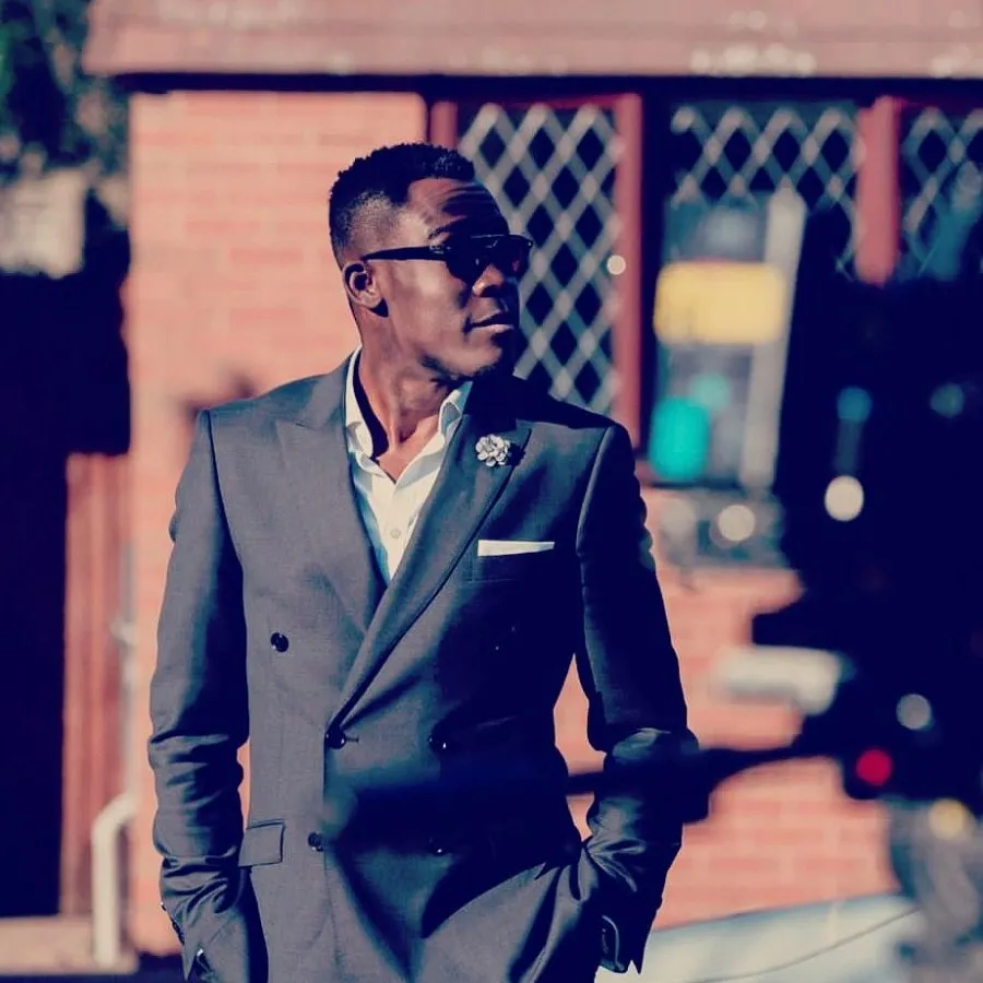 Peter in a suit being filmed on location for TV