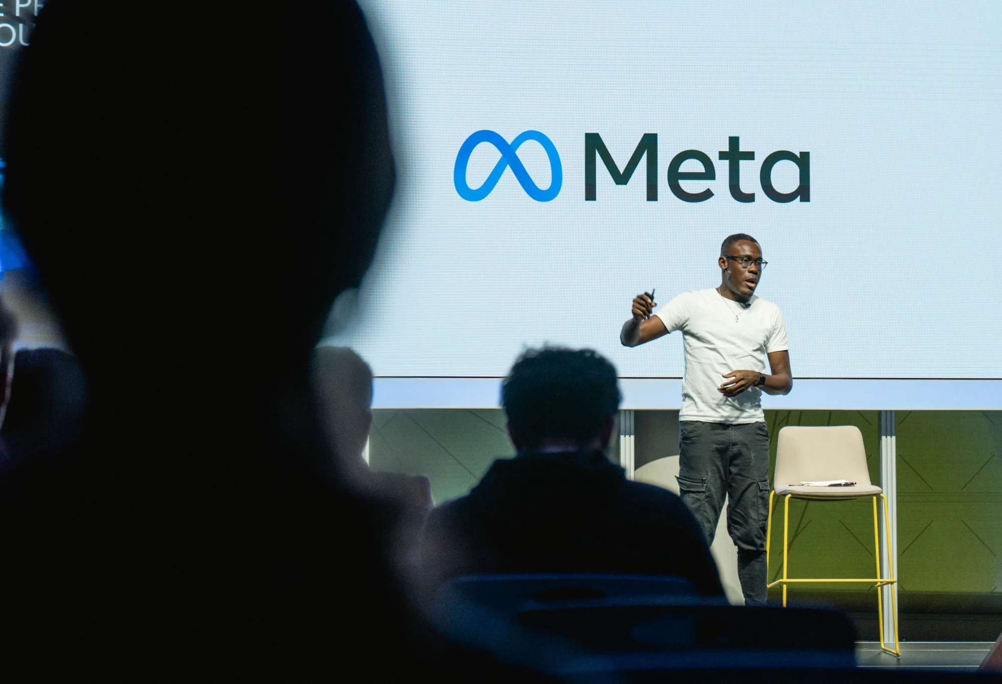 Peter Komolafe speaking on stage at Meta