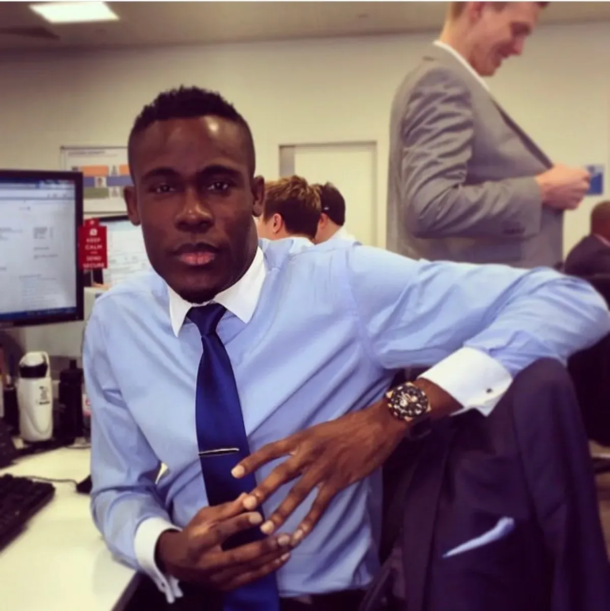 Peter in a shirt and tie at his desk during his years in financial services